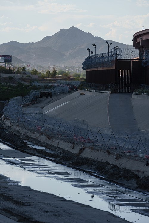 Mount Cristo Rey overlooks the Rio Grande as it trickles through a canal.